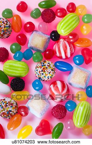 Stock Image - Brightly coloured sweets, studio shot.. Fotosearch