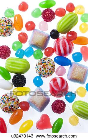 Stock Image - Brightly coloured sweets, studio shot.. Fotosearch
