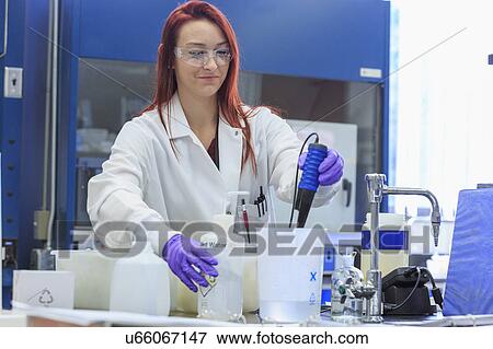 Chemist adding distilled water while measuring pH. View Large Photo Image Stock Photo - Chemist adding distilled water while measuring pH.. Fotosearch