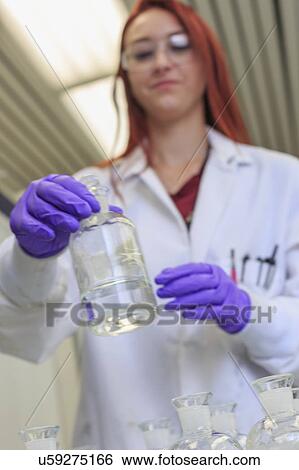 Chemist holding reagent bottle. View Large Photo Image Stock Photograph - Chemist holding reagent bottle.. Fotosearch