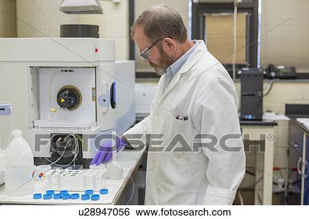 Chemist preparing automated water test. View Large Photo Image Stock Photograph - Chemist preparing automated water test.. Fotosearch