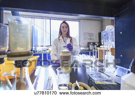 Chemist preparing graduated cylinder for standard solution. View Large Photo Image Stock Image - Chemist preparing graduated cylinder for standard solution.. Fotosearch