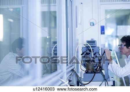 Chemist setting up a vacuum pump in a pharmaceutical laboratory. View Large Photo Image Stock Image - Chemist setting up a vacuum pump in a pharmaceutical laboratory.. Fotosearch
