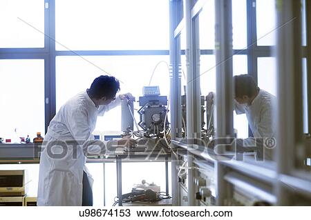 Chemist setting up a vacuum pump in a pharmaceutical laboratory. View Large Photo Image Stock Image - Chemist setting up a vacuum pump in a pharmaceutical laboratory.. Fotosearch