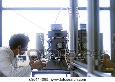 Chemist setting up a vacuum pump in a pharmaceutical laboratory. View Large Photo Image Stock Photography - Chemist setting up a vacuum pump in a pharmaceutical laboratory.. Fotosearch