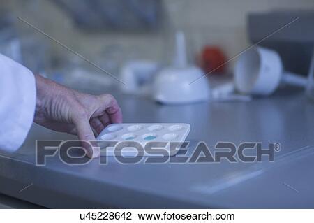 Chemist working in pharmaceutical laboratory. View Large Photo Image Stock Image - Chemist working in pharmaceutical laboratory.. Fotosearch