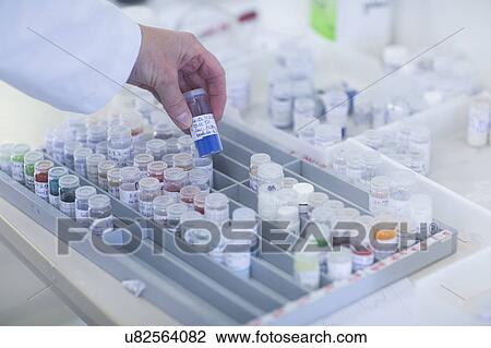 Chemist working with samples stored in crimp neck phials in a pharmaceutical laboratory. View Large Photo Image Stock Image - Chemist working with samples stored in crimp neck phials in a pharmaceutical laboratory.. Fotosearch