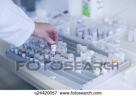 Chemist working with samples stored in crimp neck phials in a pharmaceutical laboratory. View Large Photo Image Stock Photo - Chemist working with samples stored in crimp neck phials in a pharmaceutical laboratory.. Fotosearch
