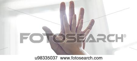 Stock Photo - Child and adult touching hands.. Fotosearch