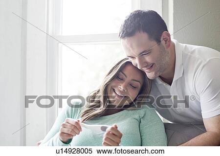 Stock Photography - Couple looking at pregnancy test.. Fotosearch