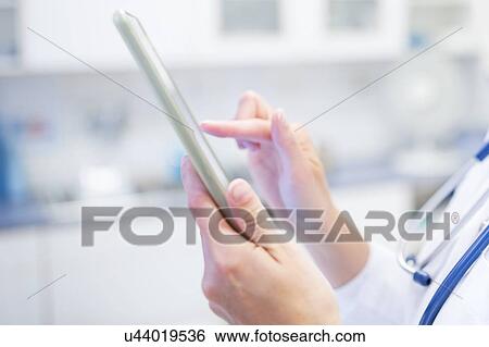 Cropped view of female doctor using digital tablet. View Large Photo Image Stock Photograph - Cropped view of female doctor using digital tablet.. Fotosearch