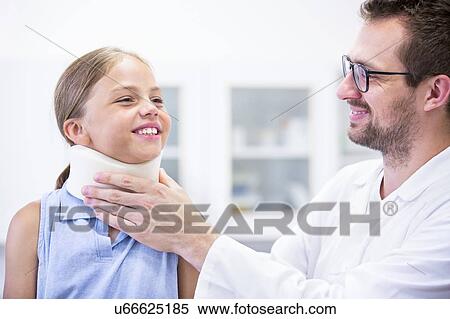 Doctor applying neck support to young girl. View Large Photo Image Stock Photography - Doctor applying neck support to young girl.. Fotosearch