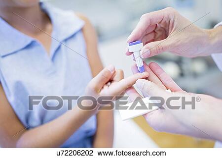 Doctor giving young girl a finger prick test. View Large Photo Image Stock Image - Doctor giving young girl a finger prick test.. Fotosearch