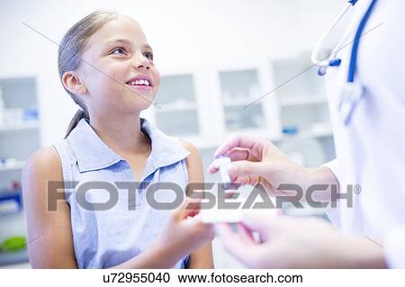 Doctor giving young girl a finger prick test. View Large Photo Image Stock Image - Doctor giving young girl a finger prick test.. Fotosearch