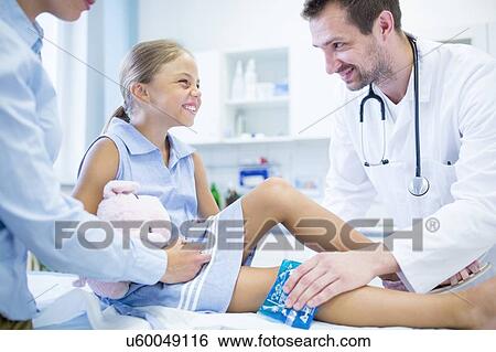 Doctor putting ice pack on young girl's leg. View Large Photo Image Stock Photograph - Doctor putting ice pack on young girl's leg.. Fotosearch