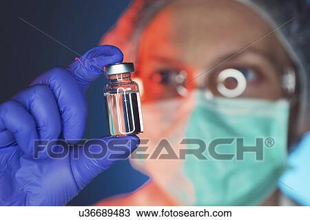 Stock Image - Doctor with drug phial. Fotosearch