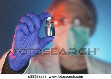 Stock Image - Doctor with drug phial. Fotosearch