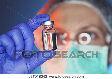 Stock Image - Doctor with drug phial. Fotosearch