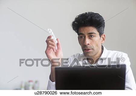 Stock Photograph - Doctor with pills. Fotosearch