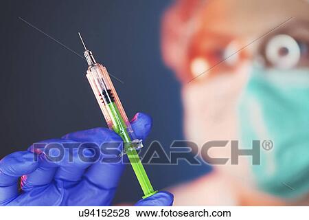 Stock Photo - Doctor with syringe. Fotosearch