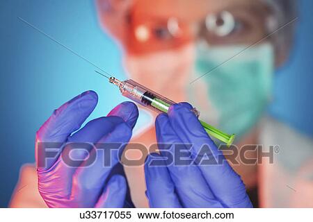 Stock Photography - Doctor with syringe. Fotosearch