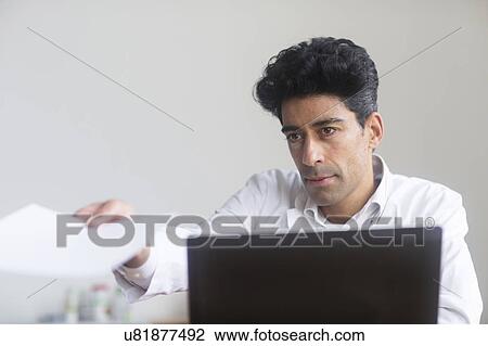 Stock Image - Doctor working on laptop. Fotosearch