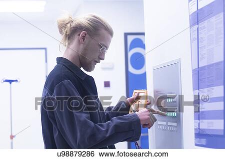 Stock Photograph - Electrician working in a hospital. Fotosearch