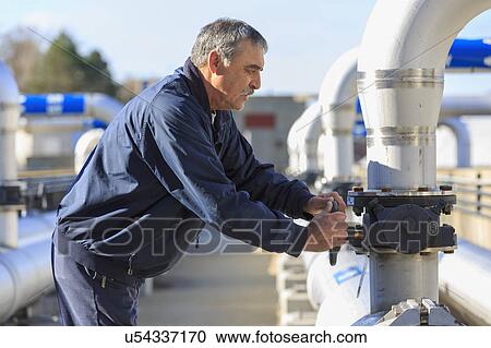 Engineer adjusting water flow control valve. View Large Photo Image Stock Image - Engineer adjusting water flow control valve.. Fotosearch