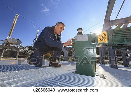 Engineer examining motor driven gate valve control. View Large Photo Image Stock Image - Engineer examining motor driven gate valve control.. Fotosearch