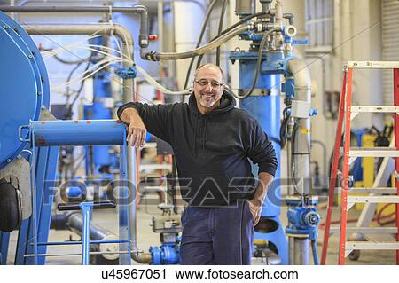 Stock Image - Engineer in water treatment plant.. Fotosearch