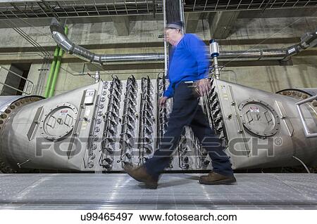 Engineer walking by water treatment plant ultraviolet ionization treatment room. View Large Photo Image Stock Photo - Engineer walking by water treatment plant ultraviolet ionization treatment room.. Fotosearch