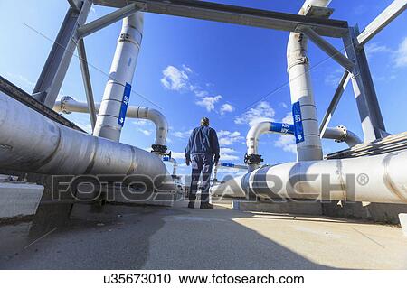 Engineer walking through water treatment plant. View Large Photo Image Stock Image - Engineer walking through water treatment plant.. Fotosearch