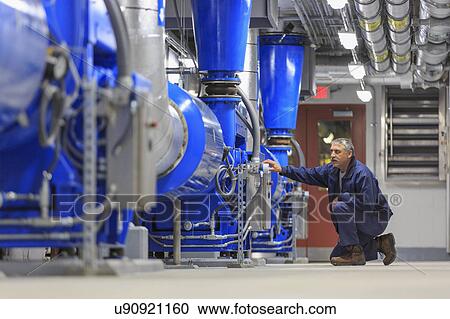 Stock Image - Engineer working on sensors.. Fotosearch