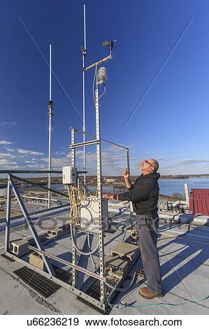 Stock Photo - Engineer working with weather sensors.. Fotosearch
