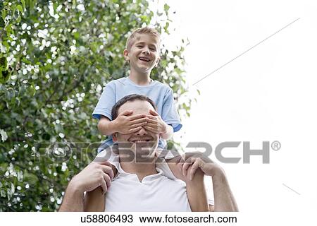 Father carrying son on his shoulders. View Large Photo Image Stock Image - Father carrying son on his shoulders.. Fotosearch