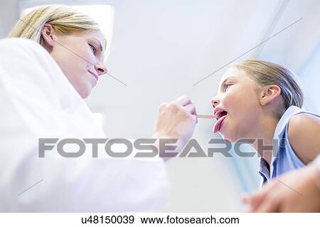 Stock Photo - Female doctor examining young girl.. Fotosearch