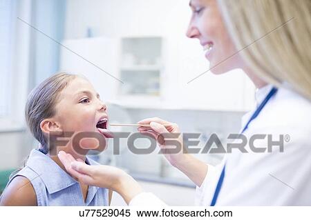 Stock Photography - Female doctor examining young girl.. Fotosearch