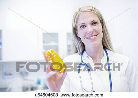 Female doctor holding pills. View Large Photo Image Stock Photo - Female doctor holding pills.. Fotosearch