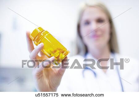 Female doctor holding pills. View Large Photo Image Stock Photography - Female doctor holding pills.. Fotosearch