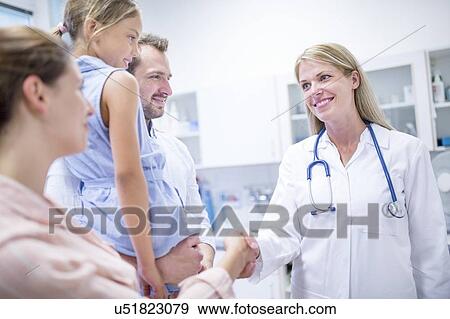 Female doctor talking to family. View Large Photo Image Stock Photo - Female doctor talking to family.. Fotosearch