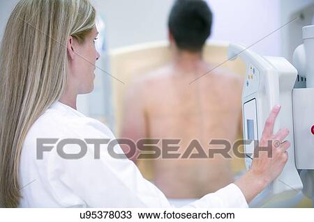 Female doctor X-raying man's chest. View Large Photo Image Stock Image - Female doctor X-raying man's chest.. Fotosearch