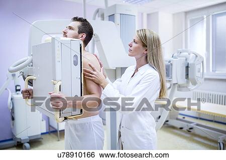 Female doctor X-raying man's chest. View Large Photo Image Stock Photograph - Female doctor X-raying man's chest.. Fotosearch