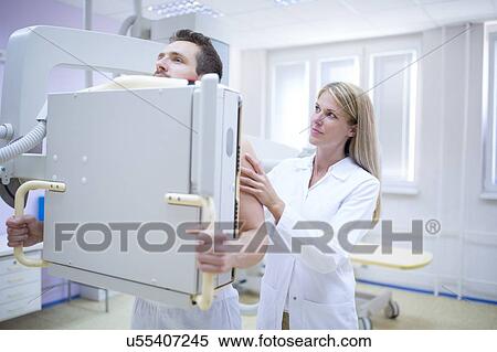Female doctor X-raying man's chest. View Large Photo Image Stock Photography - Female doctor X-raying man's chest.. Fotosearch