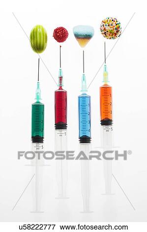 Four syringes with colourful sweets, studio shot. View Large Photo Image Stock Photo - Four syringes with colourful sweets, studio shot.. Fotosearch
