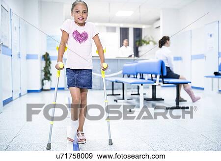 Girl walking with crutches in medical waiting room. View Large Photo Image Stock Photo - Girl walking with crutches in medical waiting room.. Fotosearch