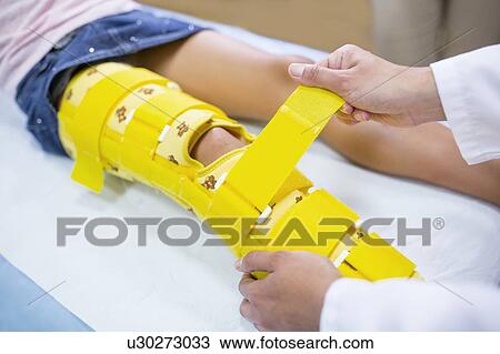 Stock Image - Girl with yellow leg brace.. Fotosearch