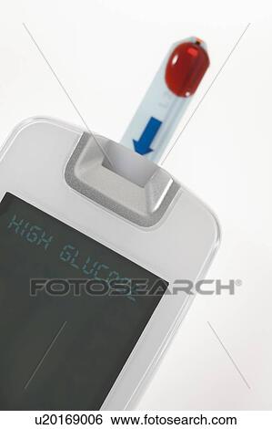 Stock Photograph - Glucose test strip being tested in reader, studio shot.. Fotosearch