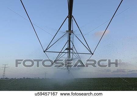 Stock Photo - Irrigation system spraying in a field in Emek Hefer, Israel.. Fotosearch