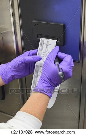 Stock Photo - Lab technician collecting data on sterilization.. Fotosearch