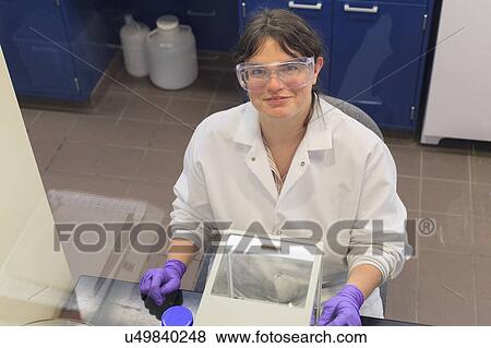 Stock Photo - Lab technician in front of scale balance.. Fotosearch